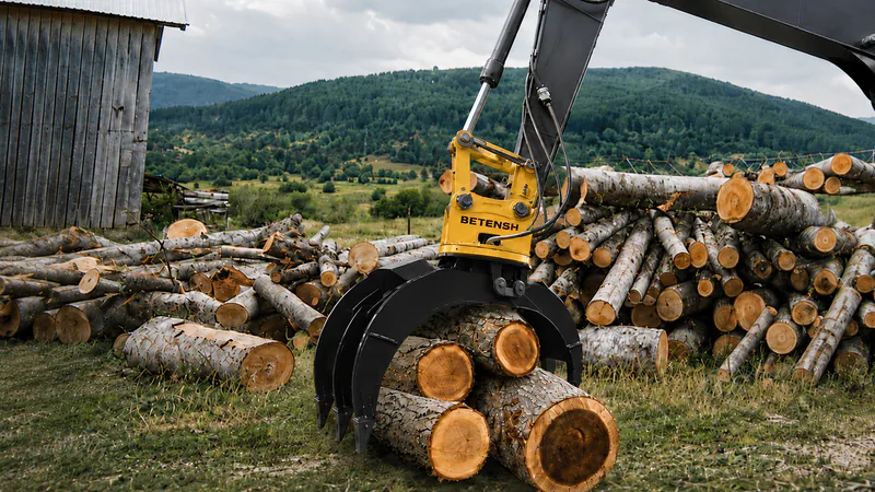 Excavator grapple handling logs